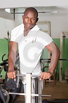 Young man doing sports exercises in a gym.