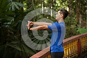 Young man doing stretching exercise relaxing and warm up