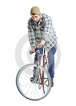 Young man doing tricks on fixed gear bicycle on a white