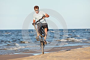 Young man doing wheelie