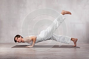 Young man doing yoga exercise