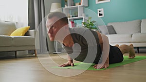 Young man doing yoga in the morning in his living room