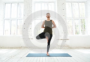 Young man doing yoga or pilates exercise