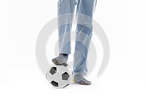 Young man dressed in pyjama and football ball