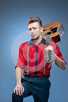 Young man dressed in rock`n`roll or rockabilly style