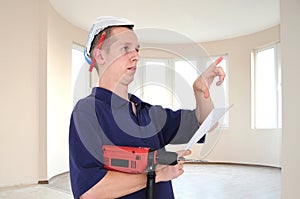 Young man with drill and paper hat