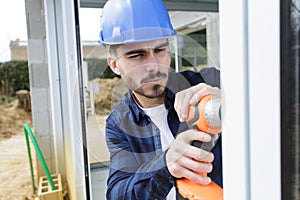 young man drilling window