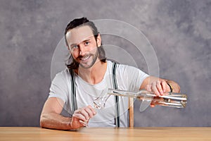 Young man drinking clear spirit