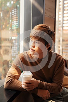 Young man drinking coffee in a cafe