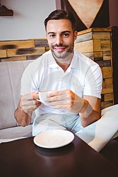 Young man drinking cup of coffee