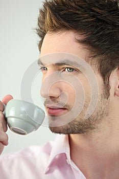 Young man drinking espresso