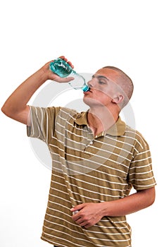 Young man drinking fresh water from bottle