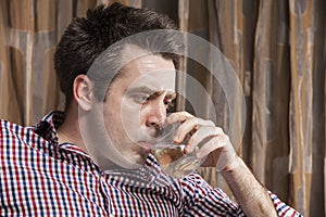 Young man drinking a glass of wine