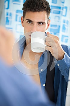 Young man drinking his morning coffee