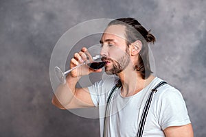 Young man drinking red wine