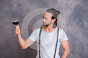 Young man drinking red wine