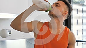 Young man drinking a smoothie drink or a protein shake