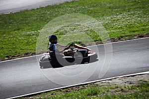 Young man drive go kart on track