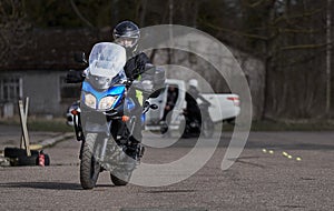 Young man drive with motorbike on street, enjoying freedom and active lifestyle, having fun on a bikers tour