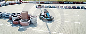 A young man drives a go kart at circuit