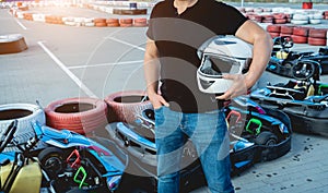 A young man drives a go kart at circuit