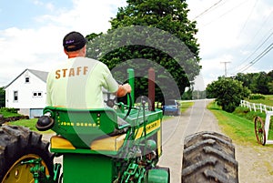 A young man drives his tractor around the farm