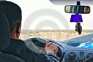 Young man driving a car.