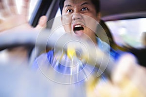 Young man driving a car shocked about to have traffic accident