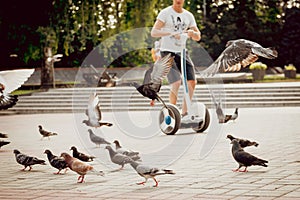 Young man driving on Segway in the park.