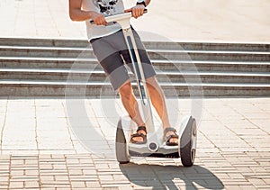 Young man driving on Segway in the park.