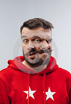 Young man with dual emotions combination on face isolated on white background, emotional and expressive