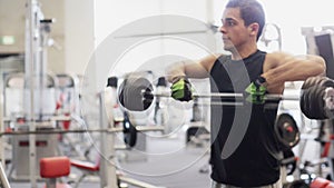 Young man with dumbbell in gym