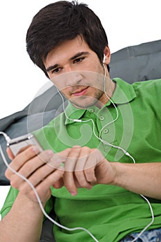 Young man with ear buds listening to music