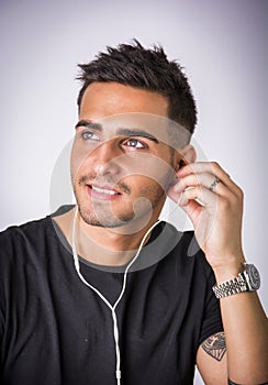 Young man with earphones listening to music