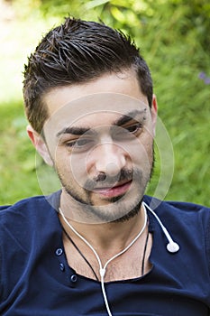 Young man with earphones outdoors