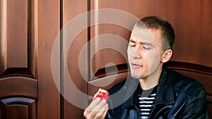 young man eating apple.