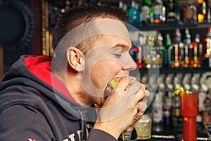 Young man eating a hamburger