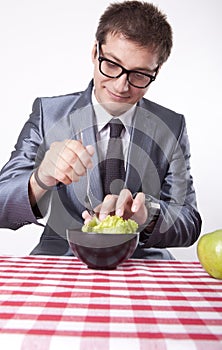 Young man eating salad