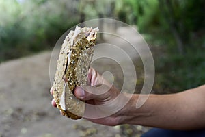 Young man eating a sandwich outdoors