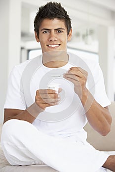 Young Man Eating Yogurt