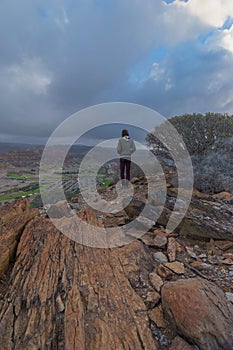 Young man on the edge of mountain