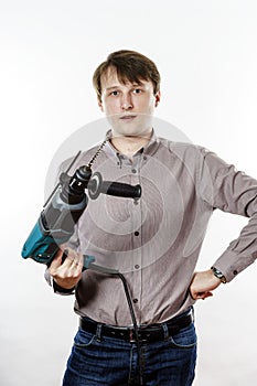 Young man with electric drilling machine isolated on white