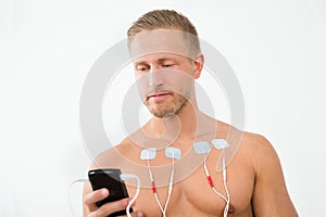 Young man with electrodes on chest