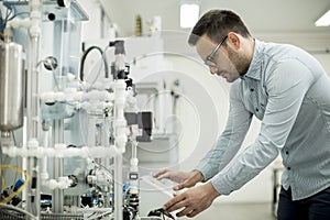 Young man in the electronic workshop