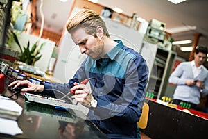 Young man in electronics workshop