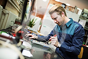 Young man in electronics workshop