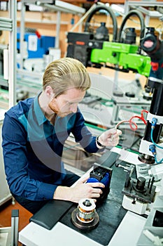 Young man in electronics workshop