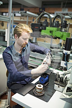Young man in electronics workshop