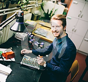 Young man in electronics workshop