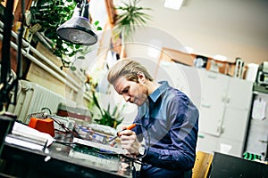 Young man in electronics workshop